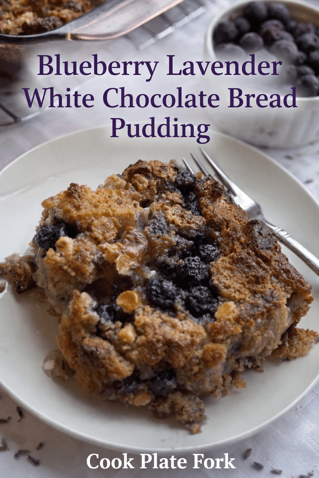 Blueberry Lavender White Chocolate Bread Pudding served warm with blueberries and white chocolate in a baked custard dessert.